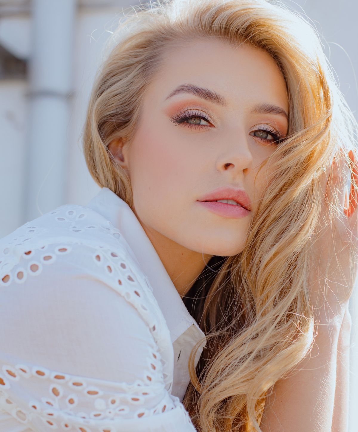 Young woman with long blonde hair, soft expression.